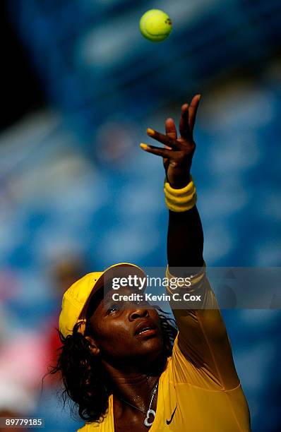 Serena Williams serves against Sybille Bammer of Austria during Day 4 of the Western & Southern Financial Group Women's Open on August 13, 2009 at...