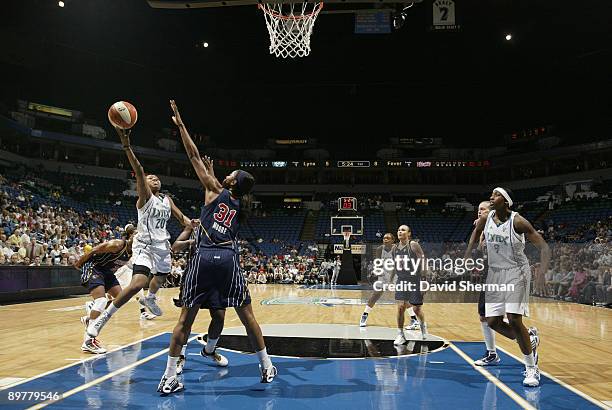 Renee Montgomery of the Minnesota Lynx goes for the basket against Jessica Moore of the Indiana Fever during the game on August 13, 2009 at the...