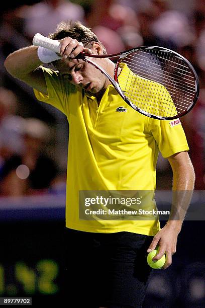 Stanilas Wawrinka of Switzerland wipes his forehead before serving against Roger Federer of Switzerland during the Rogers Cup at Uniprix Stadium on...