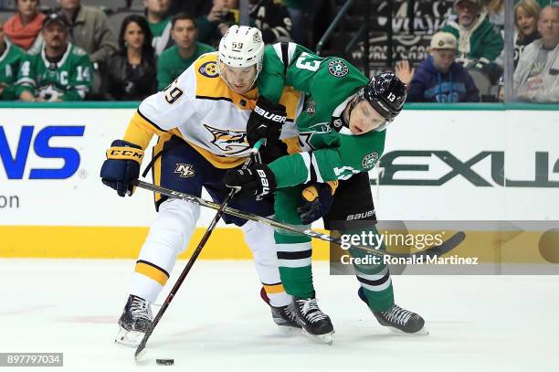 Mattias Janmark of the Dallas Stars skates for the puck against Roman Josi of the Nashville Predators in the first period at American Airlines Center...