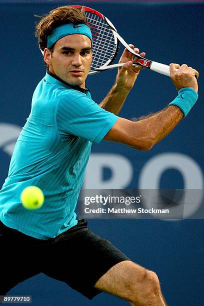 Roger Federer of Switzerland returns a shot against Stanilas Wawrinka of Switzerland during the Rogers Cup at Uniprix Stadium on August 13, 2009 in...