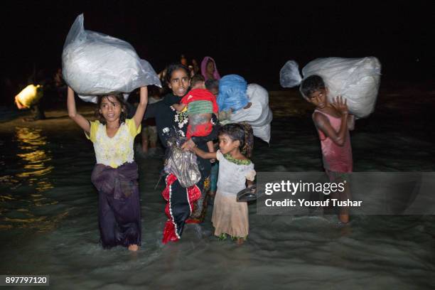 Boats full of people continue to arrive along the shores of the Naf River as Rohingya come in the safety of darkness September 29, 2017 on Shah Porir...