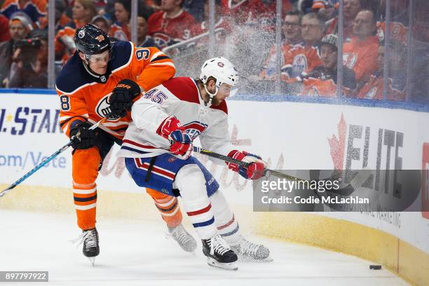 Jesse Puljujarvi of the Edmonton Oilers battles against Joe Morrow of the Montreal Canadiens at Rogers Place on December 23, 2017 in Edmonton, Canada.