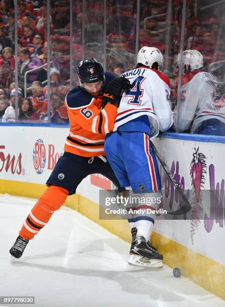 Adam Larsson of the Edmonton Oilers battles for the puck against Phillip Danault of the Montreal Canadiens on December 23, 2017 at Rogers Place in...