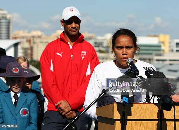Michael O'Loughlin of the Sydney Swans looks on as former athlete Cathy Freeman launches P&O Cruises "Walk The Decks" fundraising project onboard...