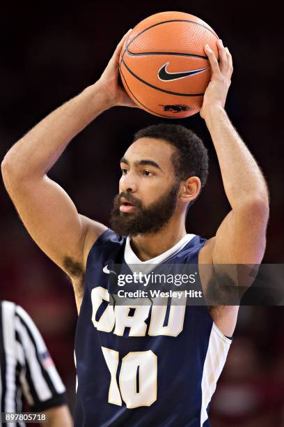 Sam Kearns of the Oral Roberts Golden Eagles looks to make a pass during a game against the Arkansas Razorbacks at Bud Walton Arena on December 19,...