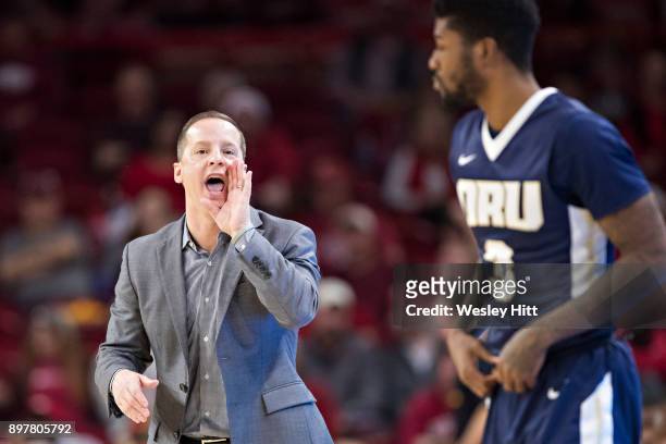 Head Coach Paul Mills yells to Jontray Harris of the Oral Roberts Golden Eagles dribbles during a game against the Arkansas Razorbacks at Bud Walton...