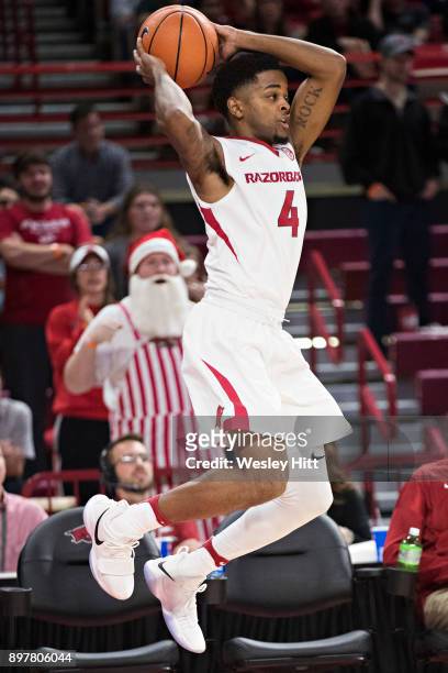 Daryl Macon of the Arkansas Razorbacks saves the ball from going out of bounds during a game against the Oral Roberts Golden Eagles at Bud Walton...