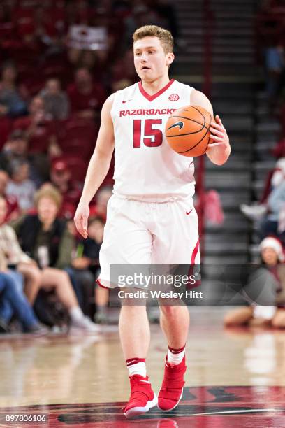 Jonathan Holmes of the Arkansas Razorbacks dribbles down the court during a game against the Oral Roberts Golden Eagles at Bud Walton Arena on...