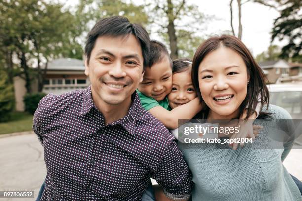 happy family of four - chinese family stock pictures, royalty-free photos & images