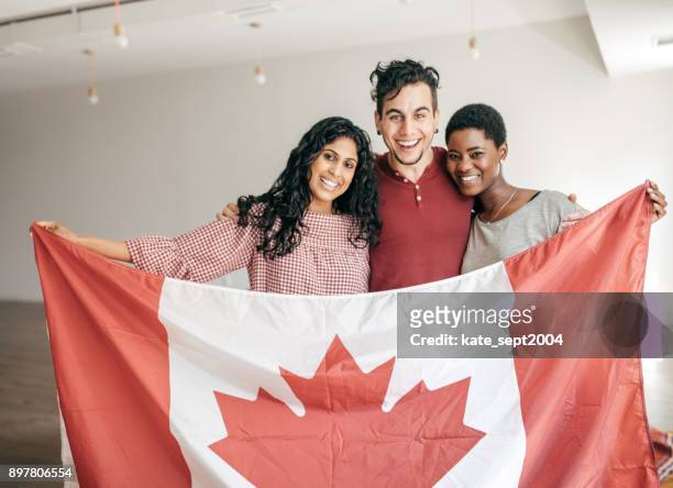 students holding canadian flag - canada flag stock pictures, royalty-free photos & images