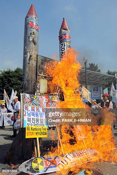 South Korean conservative activists burn mock North Korean missiles during an anti-North Korea rally in Seoul on August 14, 2009. South Korea's...