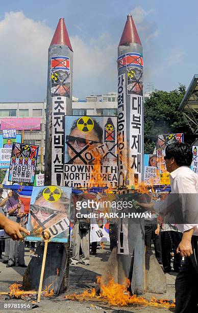 South Korean conservative activists burn mock North Korean missiles during an anti-North Korea rally in Seoul on August 14, 2009. South Korea's...
