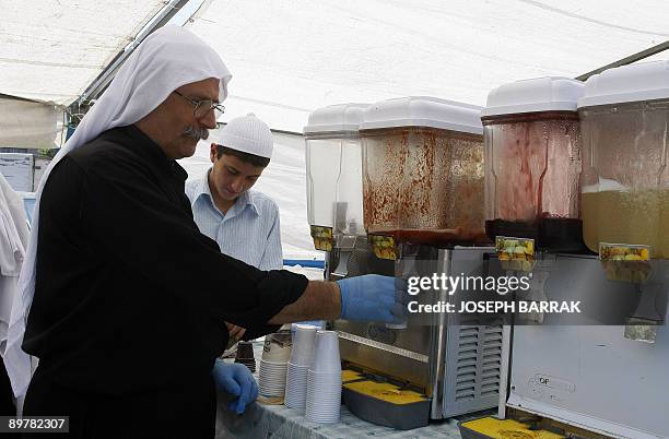 Lebanese Druze Hussein Abu Mansour sells fruit juices at Beirut's first farmer's market on August 1, 2009. On an parking lot in the heart of Beirut,...