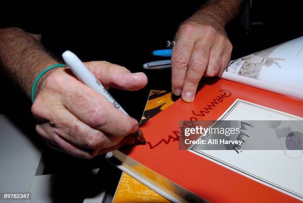 Official Woodstock photographer Henry Diltz signs a copy of "The Woodstock Experience" at a celebration of Woodstock 40 years later at Morrison Hotel...