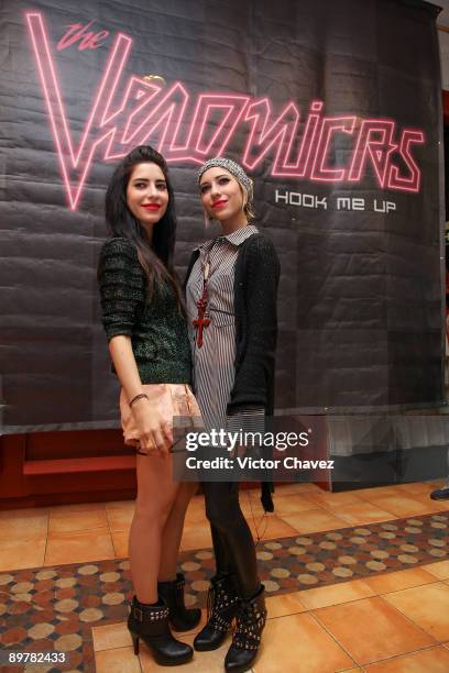 Lisa Origliasso and Jessica Origliasso of The Veronicas pose for photographs during their showcase and autograph signing at MixUp Plaza Loreto on...