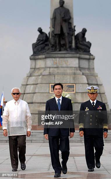 Thai Prime Minister Abhisit Vejjajiva walks with Manila Mayor Alfredo Lim and Philippine Navy Chief Ferdinand Golez during a wreath laying ceremony...