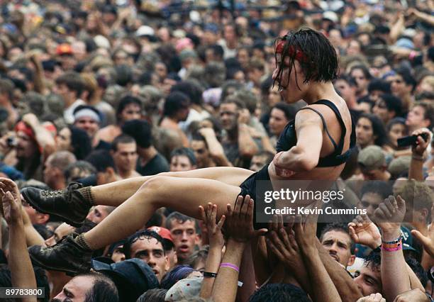 Young woman is carried over the heads of the crowd at the Woodstock '94 music festival, Saugerties, New York, 12th-14th August 1994.