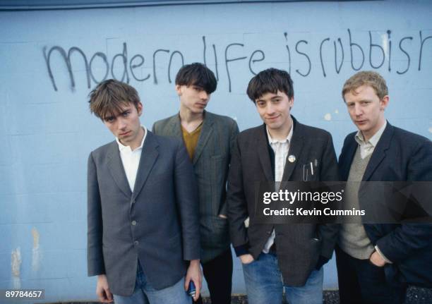 English alternative rock band Blur pose in front of the graffiti slogan 'Modern Life is Rubbish', the title of their 1993 album. From left to right,...