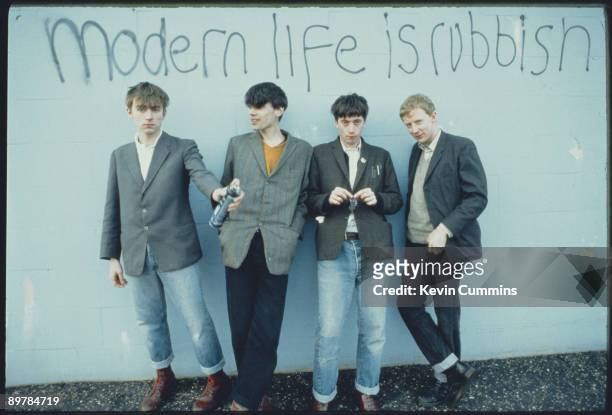 English alternative rock band Blur pose in front of the graffiti slogan 'Modern Life is Rubbish', the title of their 1993 album. From left to right,...