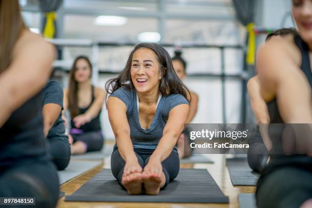 touch your toes - women forties feet stock pictures, royalty-free photos & images