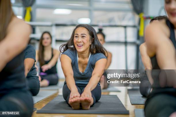 touch your toes - asian yoga stock pictures, royalty-free photos & images