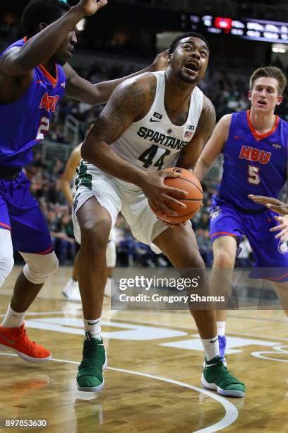 Nick Ward of the Michigan State Spartans looks to get off a shot while playing the Houston Baptist Huskies at the Jack T. Breslin Student Events...