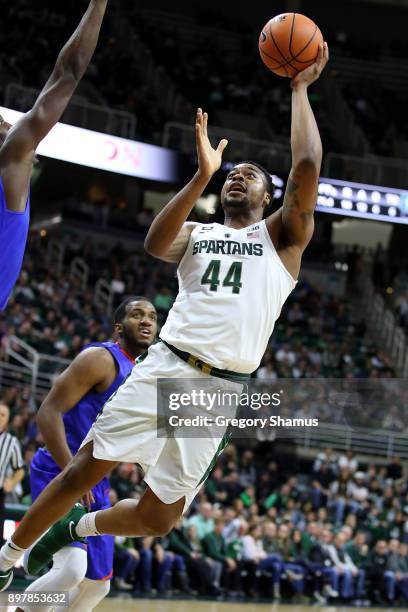 Nick Ward of the Michigan State Spartans takes a first half shot next to Philip McKenzie of the Houston Baptist Huskies at the Jack T. Breslin...