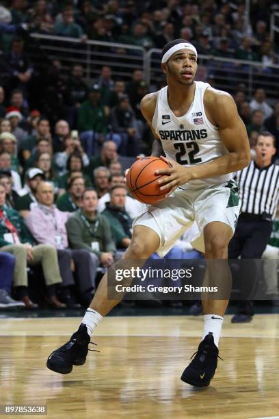 Miles Bridges of the Michigan State Spartans dribbles against against the Houston Baptist Huskies at the Jack T. Breslin Student Events Center on...
