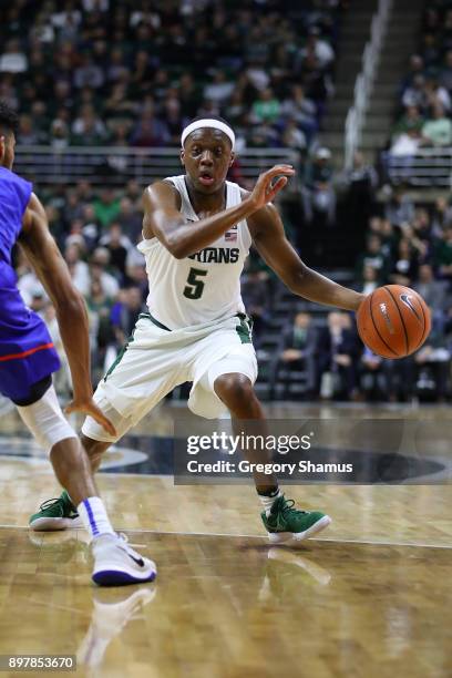Cassius Winston of the Michigan State Spartans dribbles against against the Houston Baptist Huskies at the Jack T. Breslin Student Events Center on...