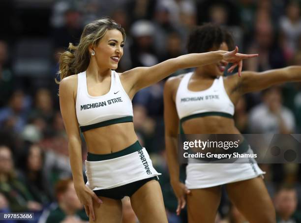 Michigan State Spartans cheerleaders perform at the game against the Houston Baptist Huskies at the Jack T. Breslin Student Events Center on December...