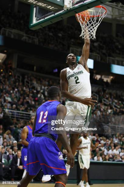 Jaren Jackson Jr. #2 of the Michigan State Spartans dunks over Tim Myles of the Houston Baptist Huskies during the second half at the Jack T. Breslin...