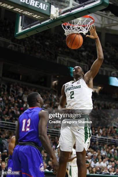 Jaren Jackson Jr. #2 of the Michigan State Spartans dunks over Tim Myles of the Houston Baptist Huskies during the second half at the Jack T. Breslin...