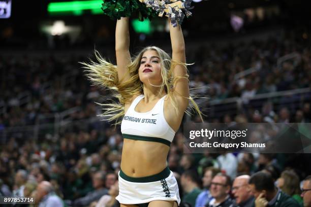 Michigan State Spartans cheerleaders perform at the game against the Houston Baptist Huskies at the Jack T. Breslin Student Events Center on December...