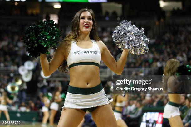 Michigan State Spartans cheerleaders perform at the game against the Houston Baptist Huskies at the Jack T. Breslin Student Events Center on December...