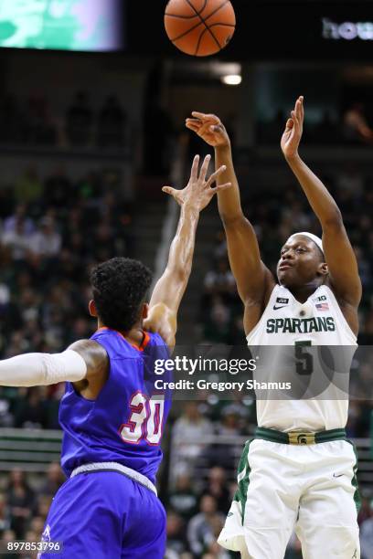 Cassius Winston of the Michigan State Spartans shoots the ball over Braxton Bonds of the Houston Baptist Huskies at the Jack T. Breslin Student...