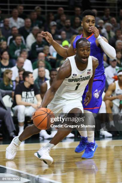 Joshua Langford of the Michigan State Spartans dribbles against the Houston Baptist Huskies at the Jack T. Breslin Student Events Center on December...