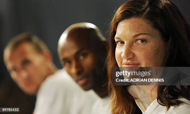 Olympic Discus Champion Stephanie Brown Trafton sits beside her teammates Jeremy Wariner and Bernard Lagat during the US athletics team press...