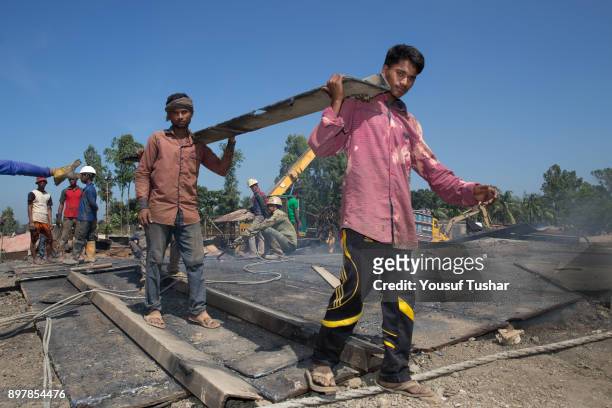 Ship breaking laborers caring parts of ship at Sitakundo ship breaking yard. The ship breaking industry at Sitakundo started its operation in 1960....