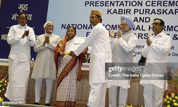 President Pratibha Patil gives away an award at the Presentation Ceremony of Kabir Puraskar and National Communal Harmony Awards also present at the...