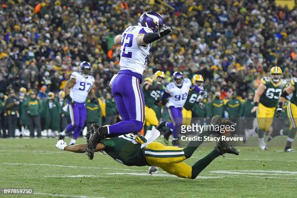 Harrison Smith of the Minnesota Vikings avoids a tackle by Randall Cobb of the Green Bay Packers after an interception in the first half at Lambeau...