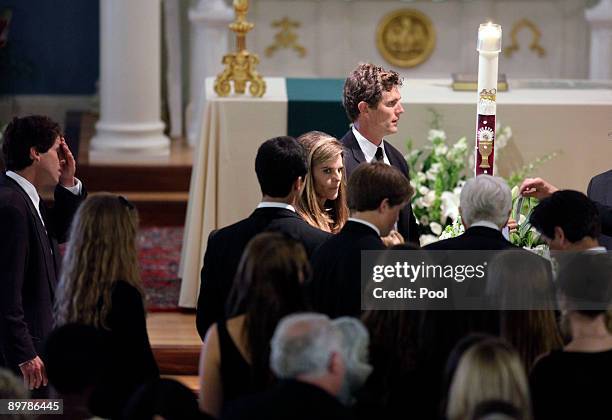 Family members, including Maria Shriver and and Anthony Shriver, stand around the coffin of Eunice Kennedy Shriver at St. Xavier Church August 14,...