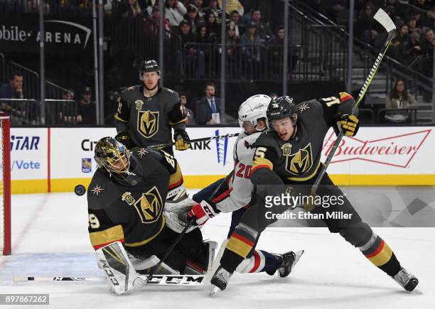Marc-Andre Fleury of the Vegas Golden Knights blocks a shot as Lars Eller of the Washington Capitals and Jon Merrill of the Golden Knights battle in...