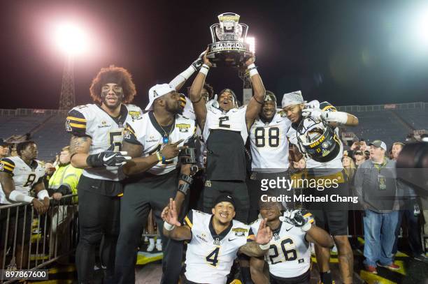 Members of the Appalachian State Mountaineers hold up the Dollar General Bowl Trophy after defeating the Toledo Rockets on December 23, 2017 at...