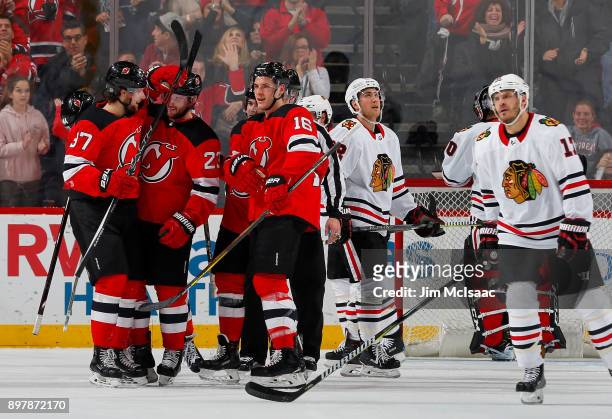 Pavel Zacha of the New Jersey Devils celebrates with teammates Stefan Noesen and Steven Santini of the New Jersey Devils after his first period goal...