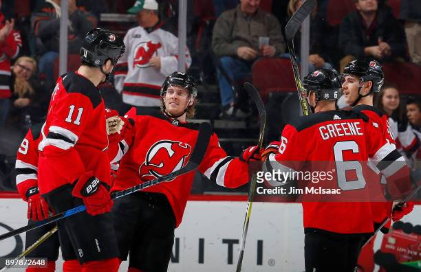 Brian Boyle of the New Jersey Devils celebrates his first period goal against the Chicago Blackhawks with teammates Blake Coleman, Andy Greene and...