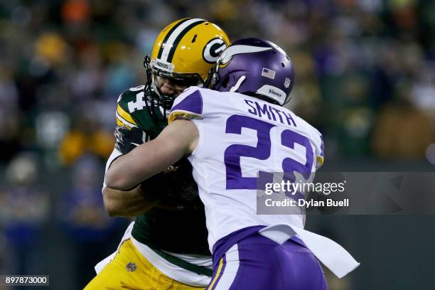 Harrison Smith of the Minnesota Vikings tackles Lance Kendricks of the Green Bay Packers in the second quarter at Lambeau Field on December 23, 2017...