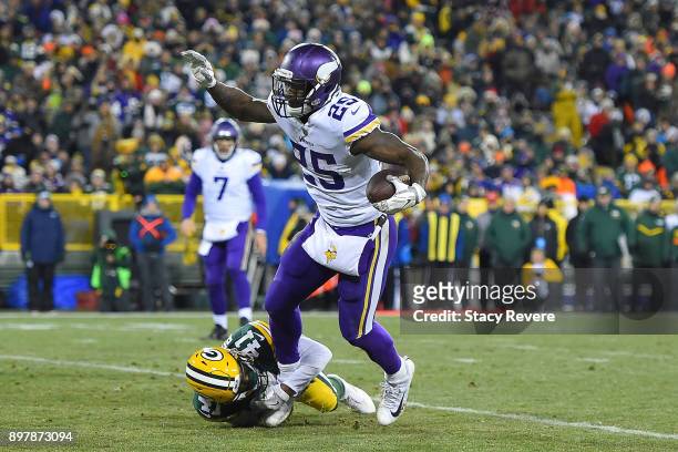 Latavius Murray of the Minnesota Vikings is brought down by Lenzy Pipkins of the Green Bay Packers during the second half at Lambeau Field on...