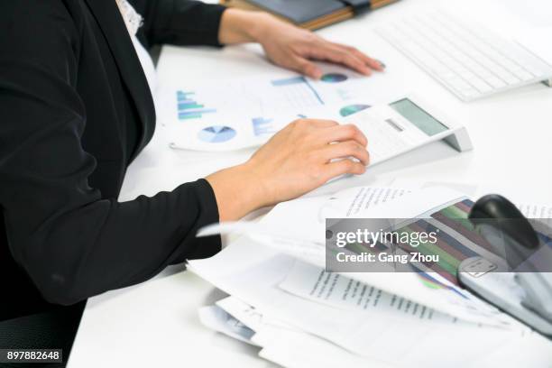 midsection of woman working on calculator - accounting firm stock pictures, royalty-free photos & images