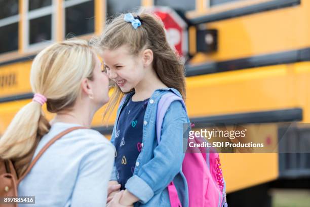 loving mom sends adorable daughter off to school - school bus kids stock pictures, royalty-free photos & images